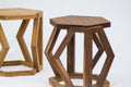 Two wooden stools with geometric designs on a white background