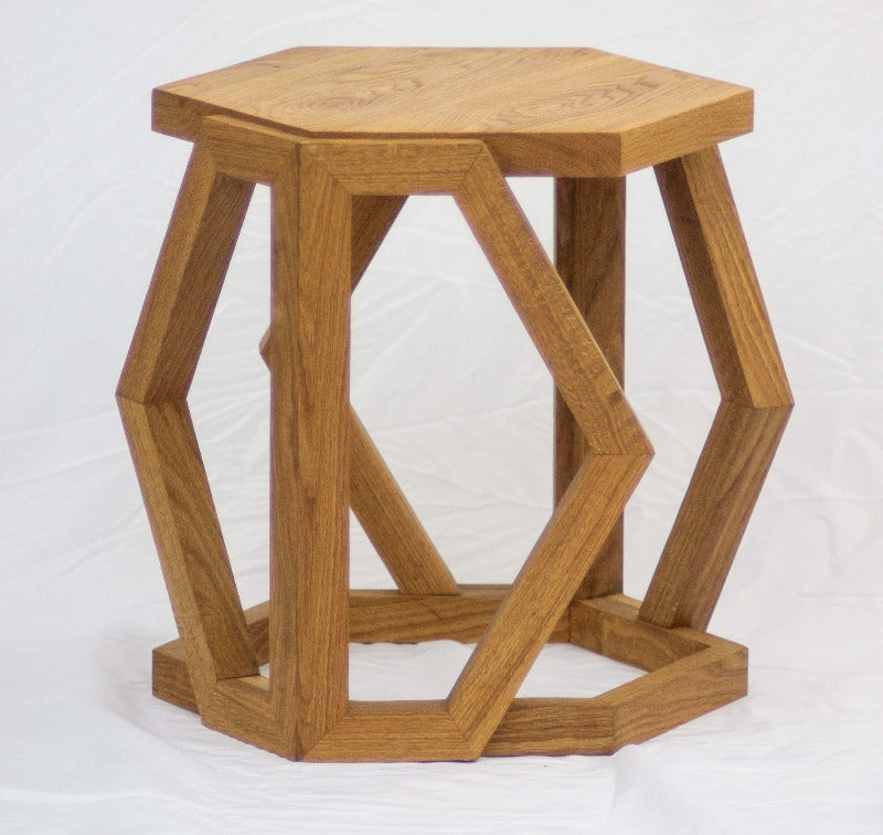 Wooden hexagonal side table on a white background